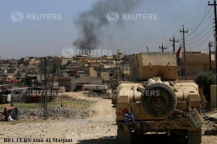 A military vehicle of Iraqi security forces drives during a battle between Iraqi forces and Islamic State militants in western Mosul